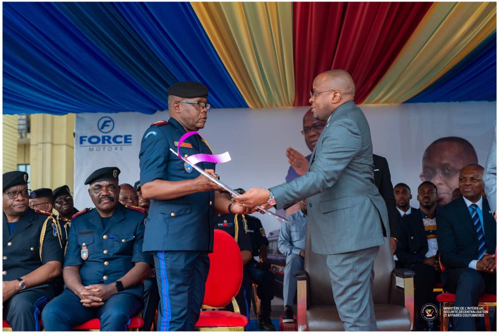 The Minister of Interior, Security, and Customary Affairs presents a police van to Police General Mr. Benjamin Alonga Boni.